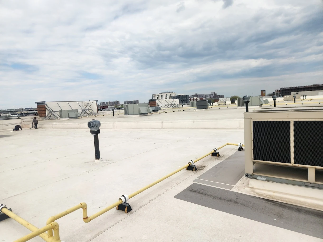 Flat roof installation by All-Star Roofing Inc. in West Islip — EPDM membrane being applied to commercial building